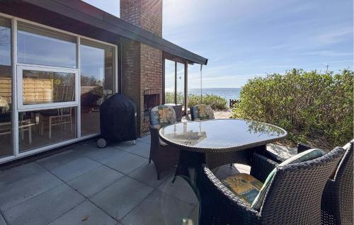 a patio with a table and chairs and the ocean at Beautiful Home In Haderslev With Wifi in Haderslev