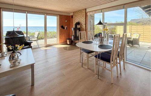 a living room with a table and chairs and the ocean at Beautiful Home In Haderslev With Wifi in Haderslev