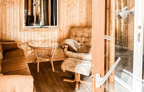 a room with a chair and a glass table at Gorgeous Home In Ulfborg With Wifi in Ulfborg