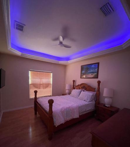 a bedroom with a bed with a blue ceiling at Pool Home in Englewood
