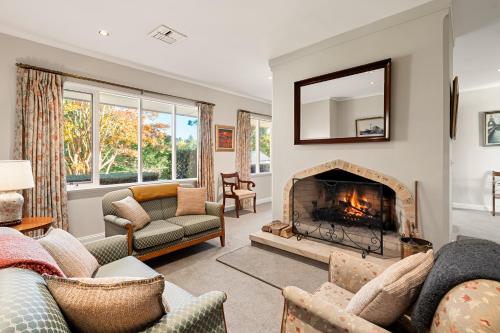 a living room with a fireplace at Wingana Homestead - Scenic Views, Bundanoon in Bundanoon