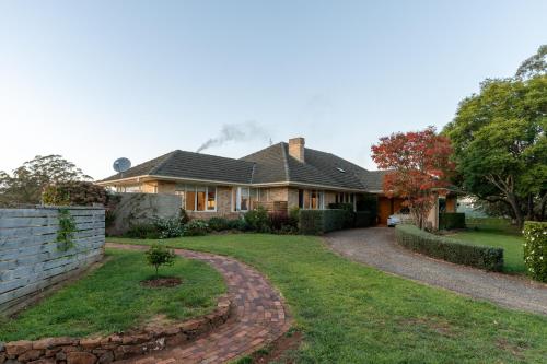 a house with a brick driveway in front of it at Wingana Homestead - Scenic Views, Bundanoon in Bundanoon