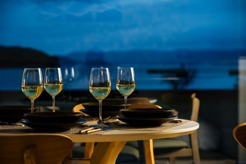a table with wine glasses and plates on it at LadolcevitA - 総檜サウナ - Private Hinoki Sauna Inn in Mitsugoe