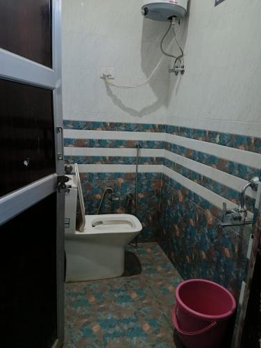 a bathroom with a toilet and a sink and a tub at Well come hotel in Baori Thikria