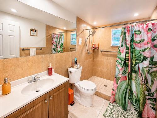 a bathroom with a toilet and a sink at Quiet & Centrally located House - PRIVATE PARKING, LAUNDRY AND STORAGE FOR LUGGAGE in Miami