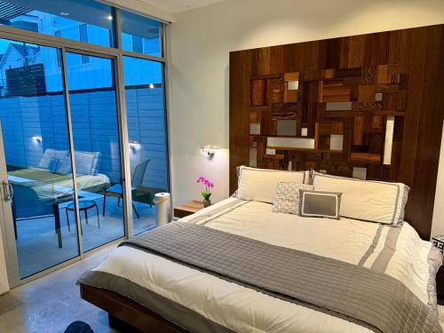 a bedroom with a large bed and a dining room at Luxury 2BR 2BA w Pool and Large Pets Allowed in Dallas