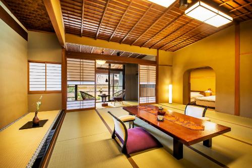 a dining room with a table and a bed at Ryoutei Ryokan Yasui in Hikone