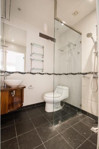a bathroom with a toilet and a sink and a shower at Scandi Apartment Boracay by Simple Realty Management in Boracay