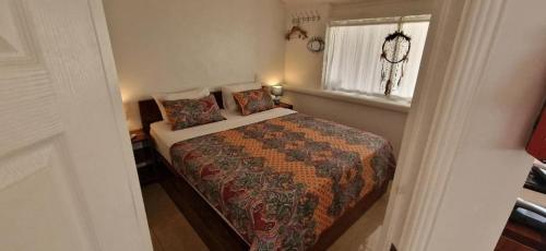 a bedroom with a bed and a window at Scandi Apartment Boracay by Simple Realty Management in Boracay