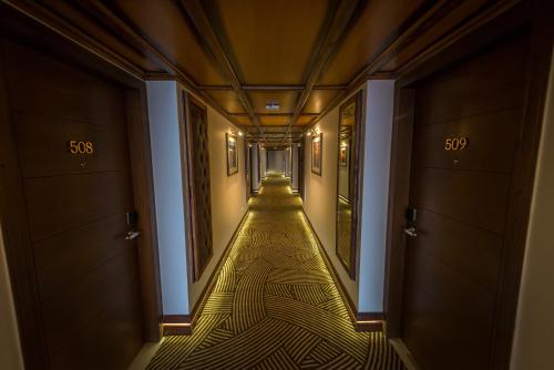 an empty hallway with a long corridor at Luxus Grand Hotel in Lahore