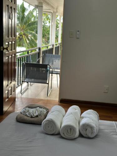 a group of towels sitting on top of a bed at The KentiGate - much more than a room in Nuku‘alofa