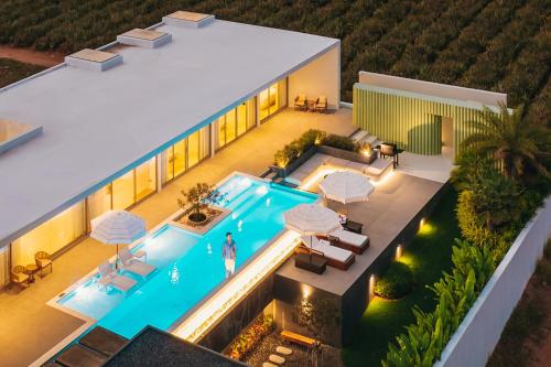 an aerial view of a house with a swimming pool at Pinepilla Poolvilla Huahin in Hua Hin