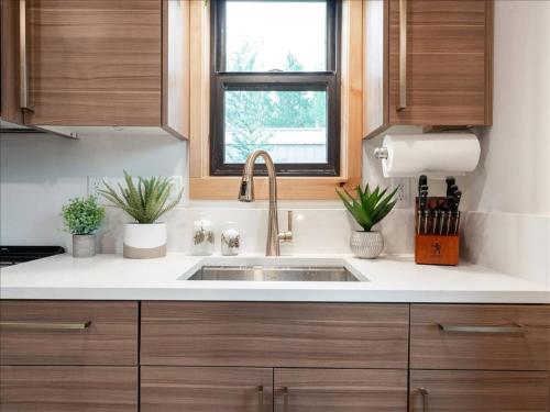 a kitchen with a sink and a window at Alpenhaus | Ski Jackson & Targhee in Victor