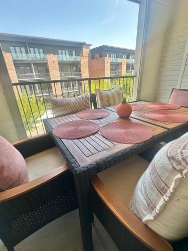 a table with plates on it on a balcony at Walk to Stadium & Cotton District, Balcony & Pool in Starkville