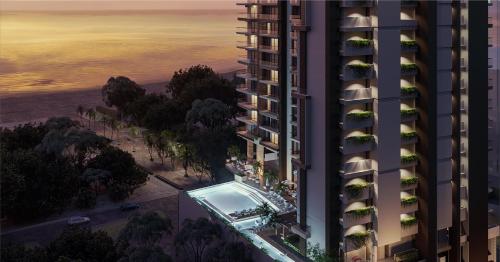 an aerial view of a building with a swimming pool at Nuruma Suites by Avia Suites in Santa Marta
