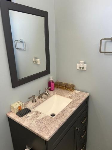 a bathroom with a sink and a mirror at 31 Runaway Meadows in Belle Air Summit