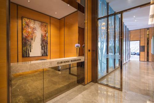 a lobby with a sign that reads city living research at Ascott Macau in Macau