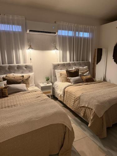 a bedroom with two beds and a window at Villa Lua, Boqueron, Puerto Rico in Cabo Rojo