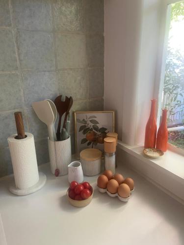 a kitchen counter with various items on a window sill at Birchmoore Studio in Penola
