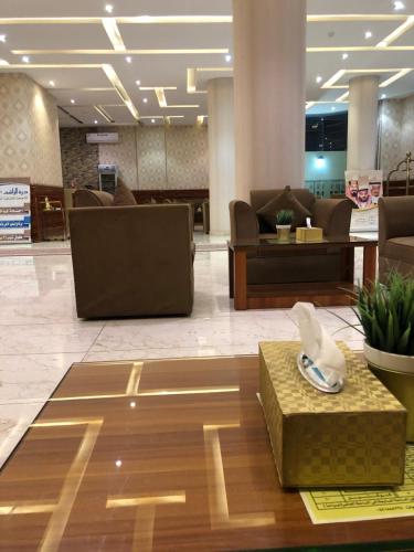 a lobby with couches and chairs in a building at شقق درةراشد للشقق المخدومة in Hafr Al-Batin