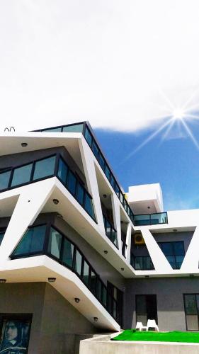 a large building with windows on the side of it at Noah's Ark Homestay in Huxi