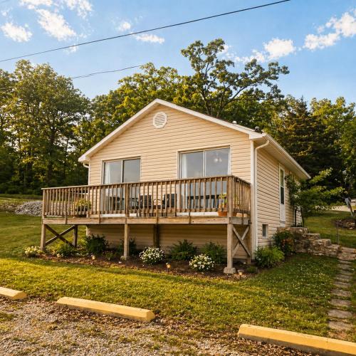 a house with a large deck on a yard at Buccaneer Bay Bungalow #8 in Sunrise Beach