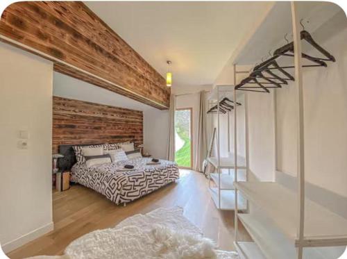 a bedroom with a bed and a wooden wall at Villa d'excellence vue lac in La Salle-en-Beaumont