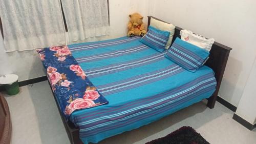 a bed with a teddy bear sitting on top of it at RanaHansa Villa in Kegalle