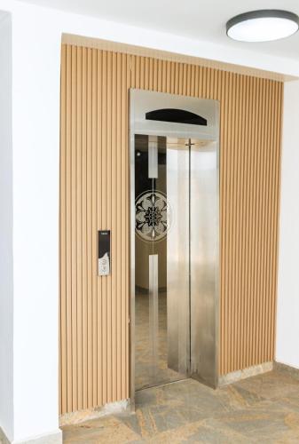 a elevator in a building with a clock on the wall at Star Hotel & Suites in Abuja