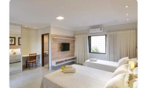 a large living room with a couch and a television at Sant copacabana in Rio de Janeiro