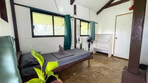 a room with a bed with a cat sitting on it at Pacifico Surf Bayay in San Isidro
