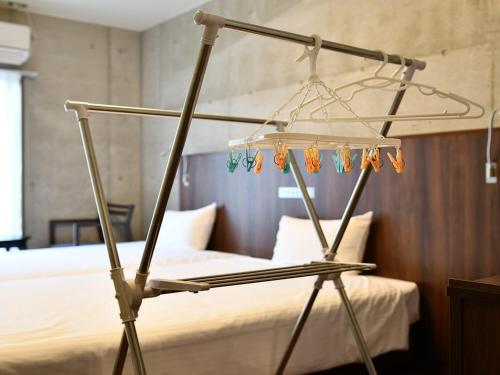 a bedroom with a bed with a metal bed frame at The BREAKFAST HOTEL PORTO Ishigakijima in Ishigaki Island