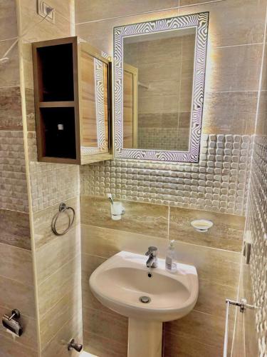 a bathroom with a sink and a mirror at Lasirena Palm Beach Sokhna Chalet in Ain Sokhna