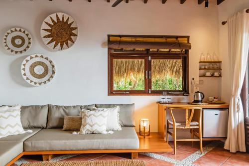 a living room with a couch and a table at Jabeki Bungalows Bingin Beach, Uluwatu in Uluwatu