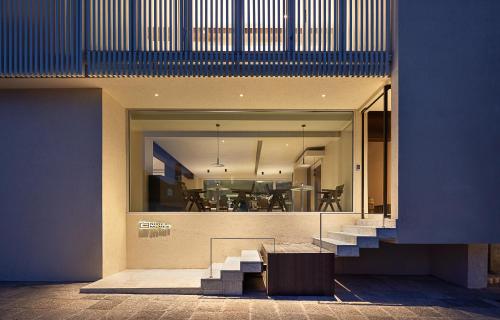 a house with stairs and a bench in front of a building at WHITEBALANCE Hotel Dali in Dali