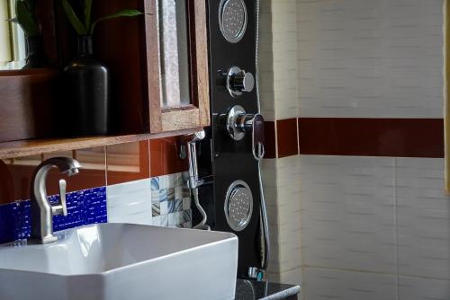 a white sink in a bathroom with a shower at Okay 1 Villa in Siem Reap
