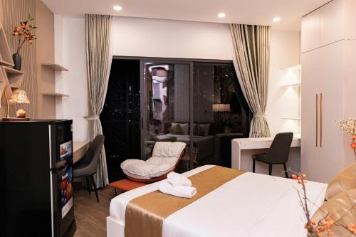 a hotel room with a bed and a living room at HomeAi Apartment - Binh Thanh near Landmark 81 in Ho Chi Minh City