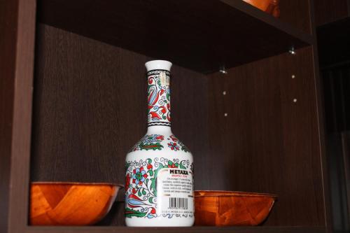 a bottle of alcohol sitting on a shelf at Casa Sofia in Bucharest