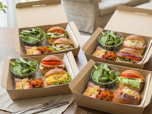 four boxes filled with different types of sandwiches and salad at RESI STAY Kuon in Kyoto