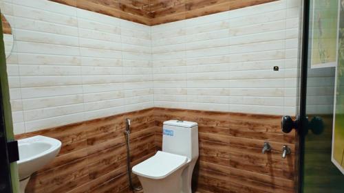 a bathroom with a toilet and a sink at SPATHODEA in Vagamon