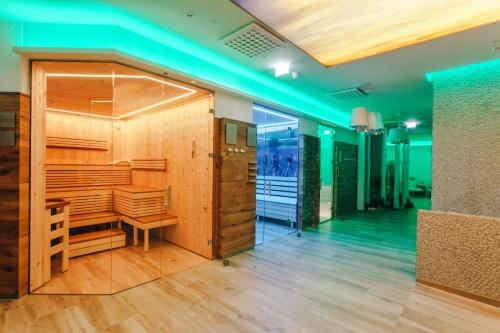 a barbershop with wood paneling and a blue light at Wellnesshotel Aumühle in Grein