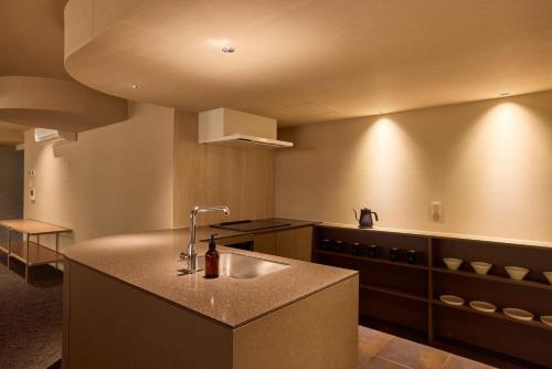 a kitchen with a sink and a counter top at 開土 KAIDO Hotel in Sapporo