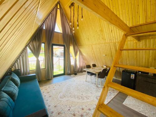 an overhead view of a living room and dining room at Kolsay A-Frame Yessen in Saty
