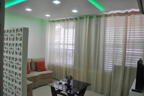 a living room with a couch and a table at Isramax Jerusalem Apartment in Bat-Yam in Bat Yam