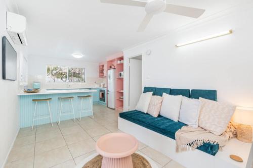a living room with a couch and a kitchen at The Springs Villa 2 in Urangan