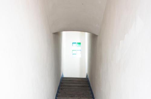 a hallway with white walls and a stair case at B&b Il Tufo in Favignana