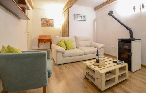a living room with a couch and a fire place at 2 Bedroom Pet Friendly Apartment In Scansano in Scansano