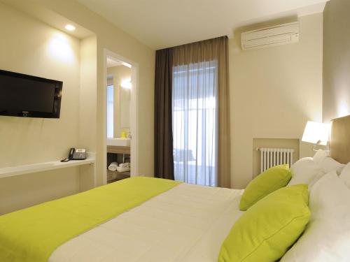 Postel nebo postele na pokoji v ubytování Hotel Concordia