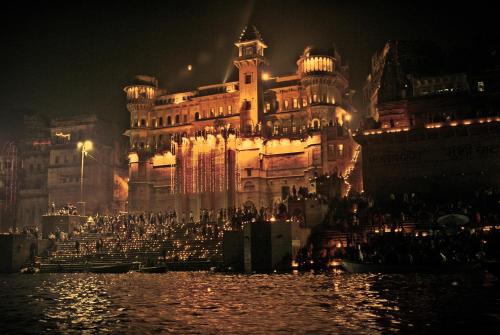 a large building with a large clock tower at Brijrama Palace, Varanasi - Heritage boutique hotel by the Ganges in Varanasi