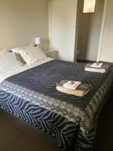 a hotel room with a bed with towels on it at Traveller's Haven in Millicent